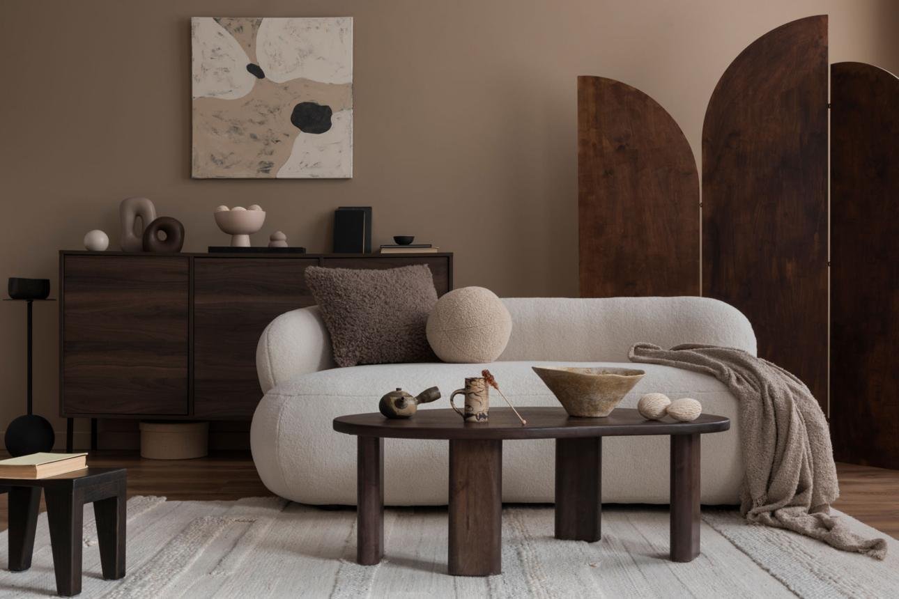 15 Warm Neutral Color Ideas for a Cozy, Timeless Home 7 Interior design of cozy living room interior with mock up poster frame, boucle sofa, stylish sideboard, ladder, pouf, books, vase with dried flowers and personal accessories. Home decor. Template.