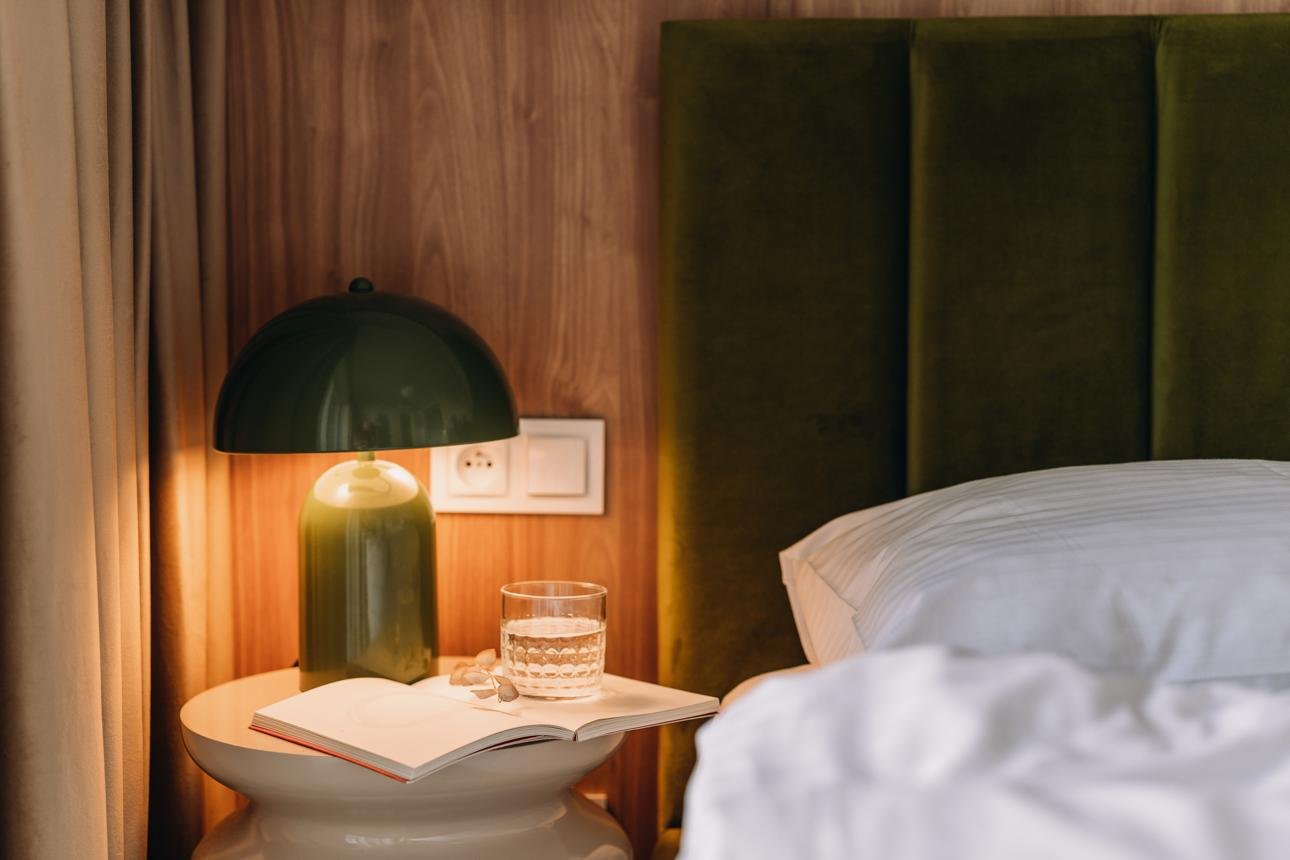Open book by bedside on a cozy morning in a modern bedroom